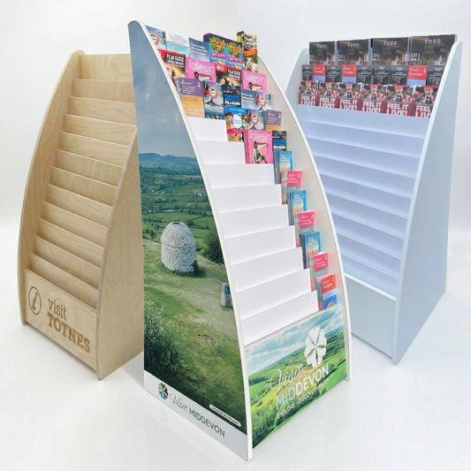 Three wooden brochures display stands with literature and promotional materials on a white background