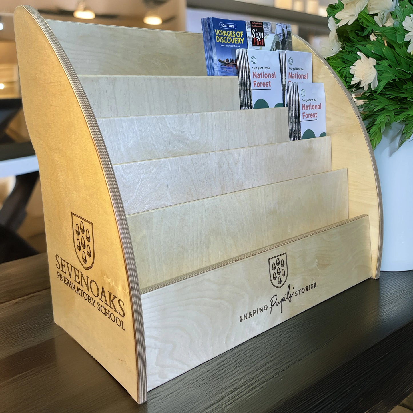 Wooden brochures dispenser with Sevenoaks Preparatory School logo holding brochures.